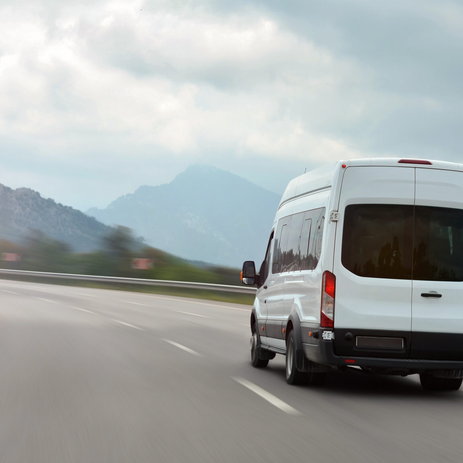 Passenger,Bus,Van,Accelerating,On,A,Background,Of,Mountains Passenger,Bus,Van,Accelerating,On,A,Background,Of,Mountains